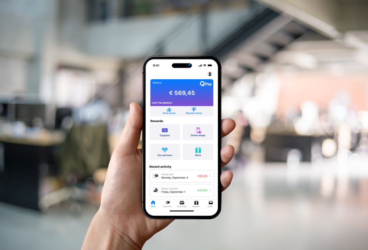 iPhone 14 Pro with an open QPay app held in man's hand